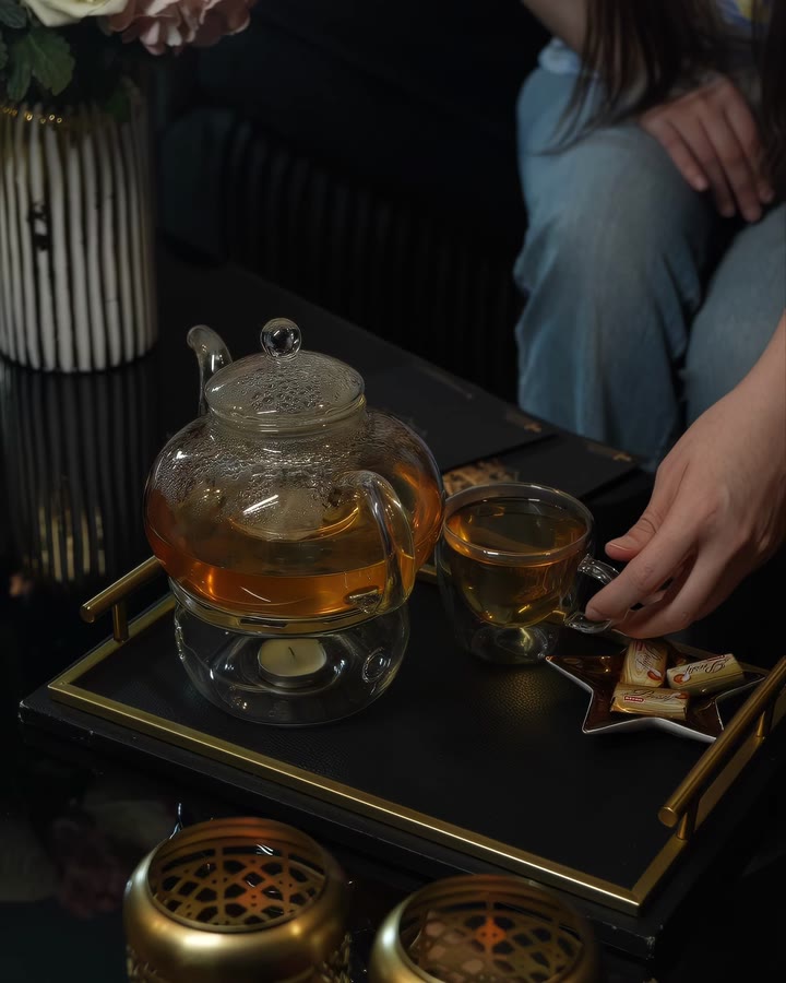 Tea poured from a glass pot onto a gold tray in the lounge